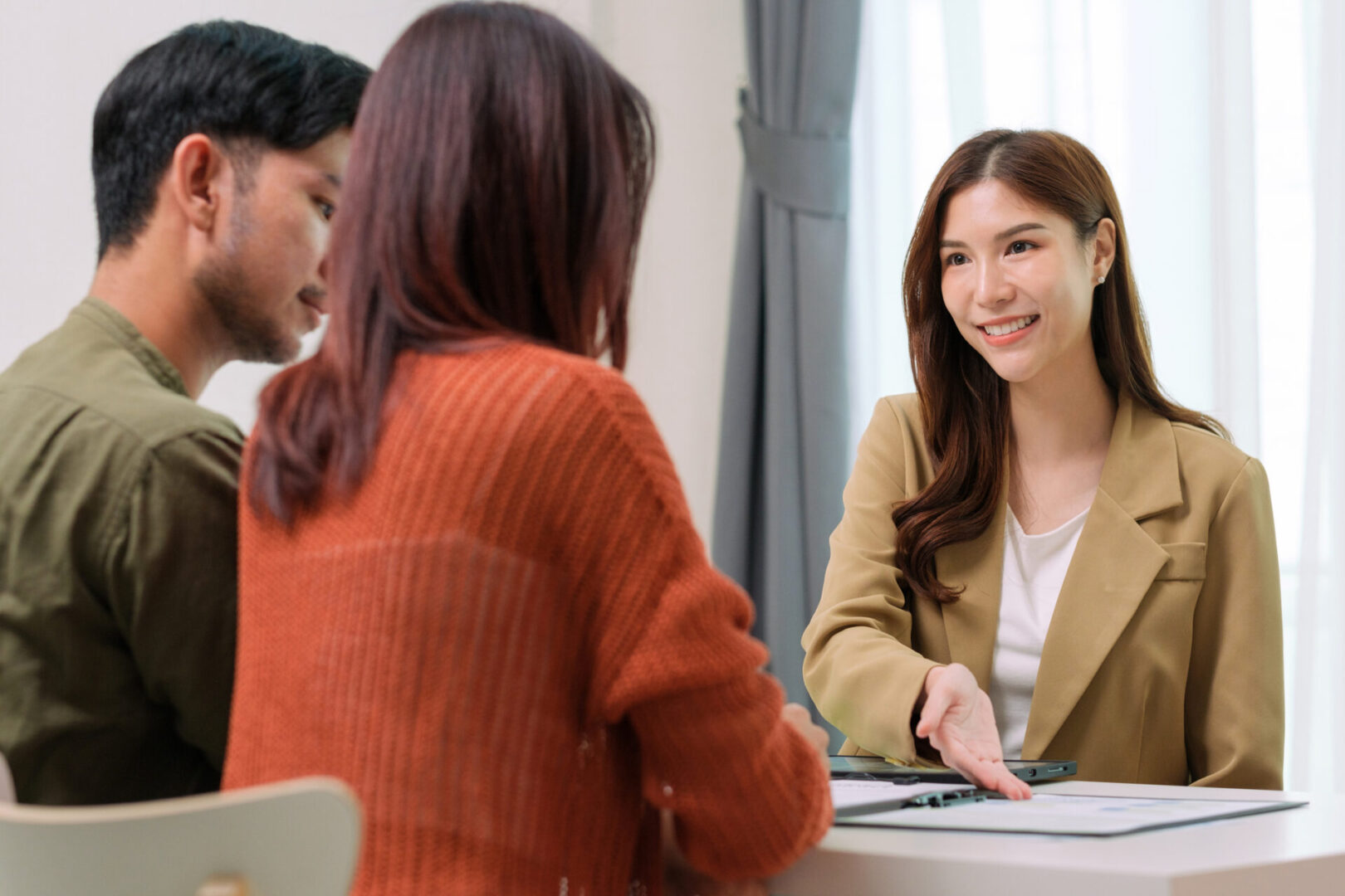 Woman welcoming couple in office